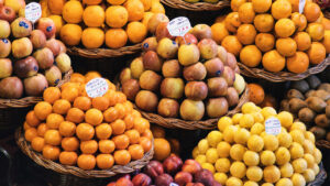 Various types of apples in baskets at a farmers market