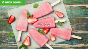 Strawberry watermelon popsicles on a table